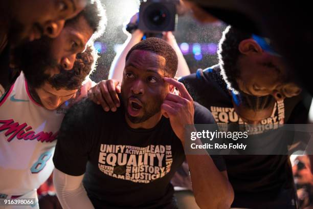 Dwyane Wade of the Miami Heat leads teammates in a huddle before the game against the Milwaukee Bucks at American Airlines Arena on February 9, 2018...