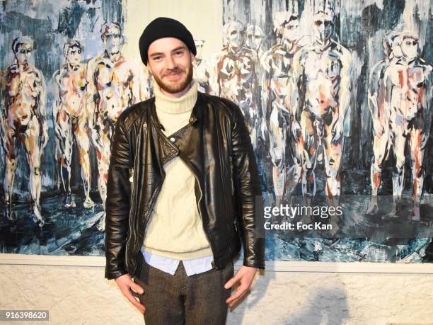 Painter Clement Denis poses with his work during the "Hors Cadre" Exhibition Gallery Opening Preview on February 9, 2018 in Paris, France.
