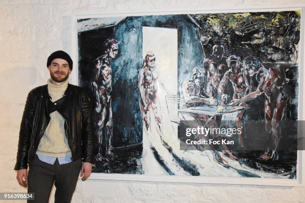 Painter Clement Denis poses with his work during the "Hors Cadre" Exhibition Gallery Opening Preview on February 9, 2018 in Paris, France.