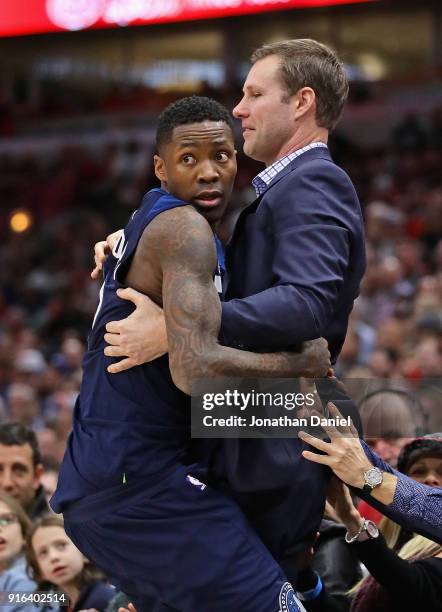 Jamal Crawford of the Minnesota Timberwolves lands in the arms of head coach Fred Hoiberg of the Chicago Bulls after diving for a loose ball at the...