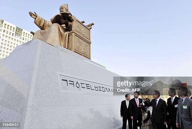South Korean President Lee Myung-Bak and government officials attend the unveiling of a bronze statue of King Sejong during a ceremony marking the...
