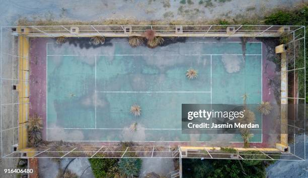 aerial photo of abandoned colourful tennis playground - forsaken film stock-fotos und bilder