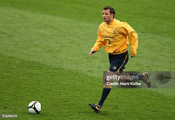 Lucas Neill runs with the ball during an Australian Socceroos training session at the Sydney Football Stadium on October 9, 2009 in Sydney, Australia.