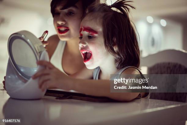 two boys having fun and using lipstick - girl sitting on boys face fotografías e imágenes de stock