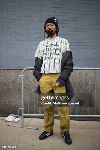 Ty Hunter is seen wearing a striped shirt and olive pants with black beanie outside the Bibhu Mohapatra show during New York Fashion Week on February...