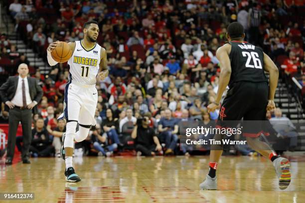 Monte Morris of the Denver Nuggets brings the ball down the court defended by Markel Brown of the Houston Rockets in the second half at Toyota Center...