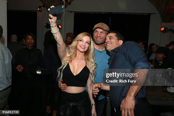Mindy Robinson, actor and former UFC fighter Randy Couture and actor Johnathon Schaech take a selfie photo at a viewing party of the Olympic Opening...