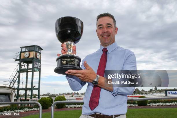 Trainer Andrew Noblet poses with the trophy after Super Cash wins the Schweppes Rubiton Stakes at Caulfield Racecourse on February 10, 2018 in...