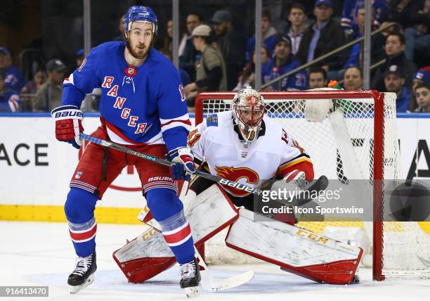 New York Rangers Center Kevin Hayes tries to screen Calgary Flames Goalie Mike Smith during the National Hockey League game between the Calgary...