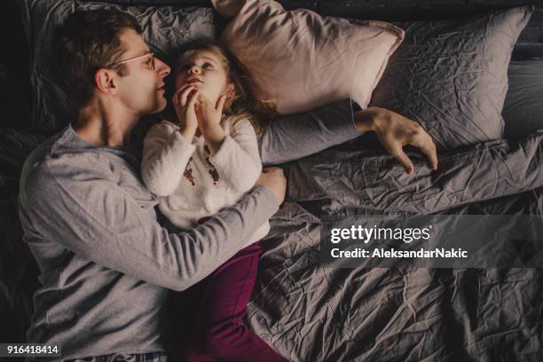 papa vertellen verhalen van de bedtijd - bedtime stockfoto's en -beelden
