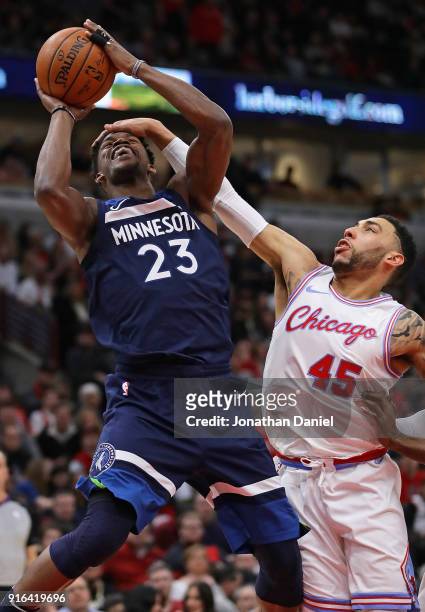 Jimmy Butler of the Minnesota Timberwolves is fouled by Denzel Valentine of the Chicago Bulls at the United Center on February 9, 2018 in Chicago,...