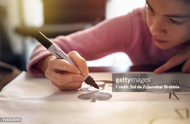little girl doing crafts on a table at home with beautiful light - kid with markers fotografías e imágenes de stock