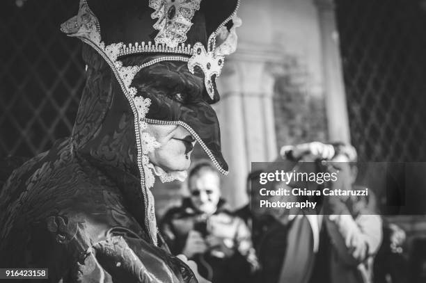 photographed masked man in venice carnival - mardi gras photos stock-fotos und bilder