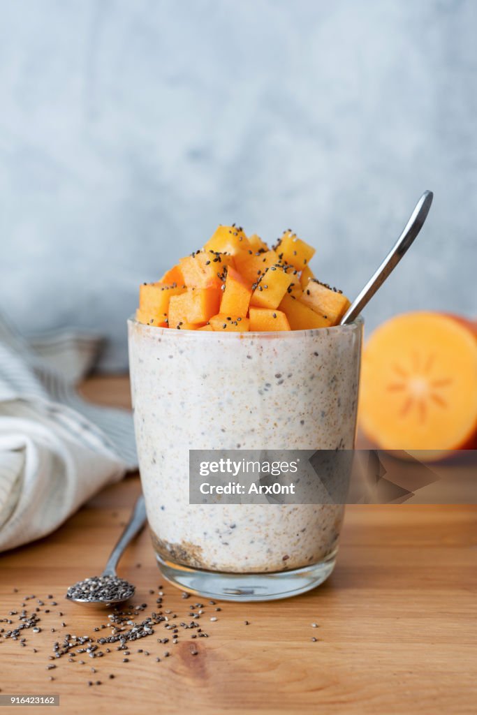 Chia seed pudding with persimmon in glass