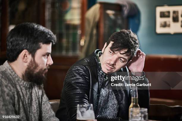 two friends drinking together in a traditional british pub. - pub mates stock-fotos und bilder