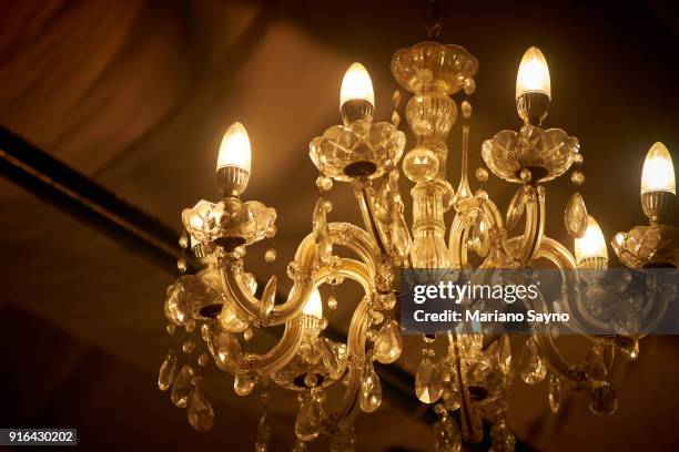 close up picture of old chandelier in ceiling - chandelier stock pictures, royalty-free photos & images