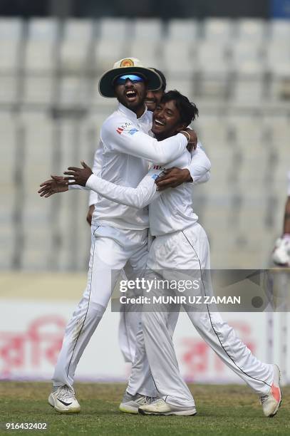 Sri Lanka cricketer Akila Dananjaya celebrates with his captain Dinesh Chandimal after the dismissal of the Bangladesh cricketer Liton Das during the...