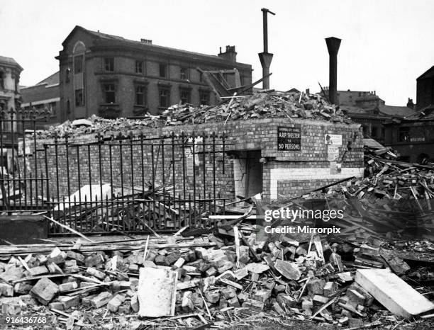 Bomb damage in Liverpool during the Second World War. A street surface shelter which withstood the strain of a tall building which fell upon it...