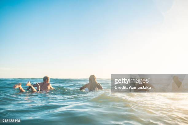 vrienden voorbereiden om te surfen in de oceaan - queensland stockfoto's en -beelden