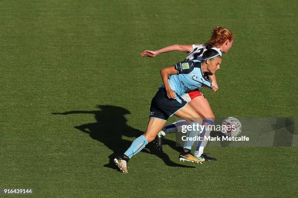 Victoria Huster of Newcastle Jets and Chloe Logarzo of Sydney FC compete for the ball during the W-League semi final match between Sydney FC and the...