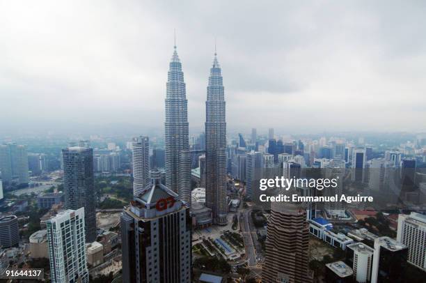 French climber Alain Robert, aka "Spiderman", climbs one of the Petronas Twin Towers on September 1, 2009 in Kuala Lumpur, Malaysia. Robert climbed...