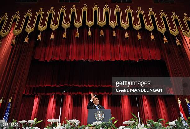 President Barack Obama waves as he arrives onto the stage to deliver his highly-anticipated address to the Muslim world on June 4, 2009 in the Grand...