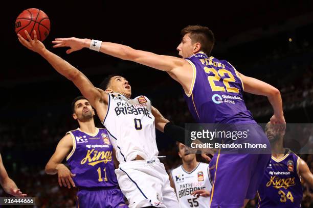 Travis Trice of the Bullets competes with Dane Pineau of the Kings during the round 18 NBL match between the Sydney Kings and the Brisbane Bullets at...