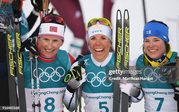Silver medalist Marit Bjoergen of Norway, gold medalist Charlotte Kalla of Sweden and bronze medalist Krista Parmakoski of Finland pose after the...
