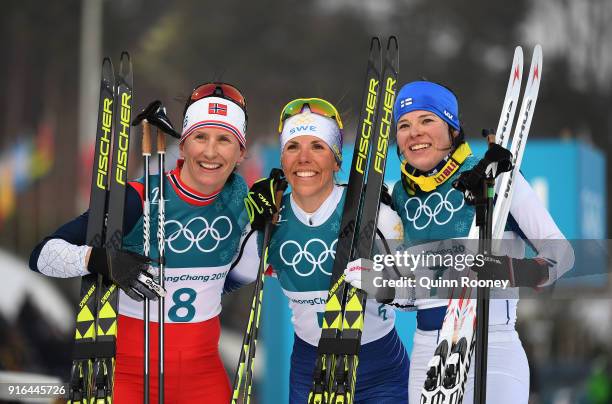 Silver medalist Marit Bjoergen of Norway, gold medalist Charlotte Kalla of Sweden and bronze medalist Krista Parmakoski of Finland pose after the...