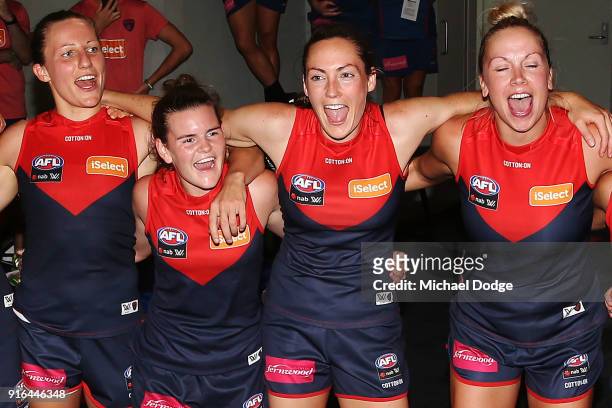Karen Paxman Lily Mithen and Meg Downie of the Demons sing the club song after winning during the round two AFLW match between the Melbourne Demons...