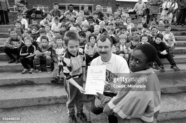 Soccer smiles from Gregory Wadsworth and Damien Wright as they receive their special certificates from Kirklees Soccer Development Officer Dai Jones...