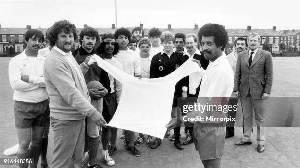 Rob Shields, left, of Toxteth United FC and the team captain Robbie Robinson pictured with their brand new strip presented to them by Barretts the...