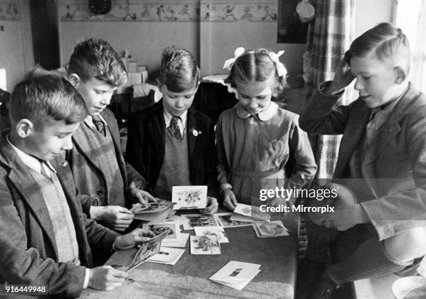 The Miles Quad from, St Neots, Cambridgeshire, England, 28th November 1945. Left to Right, Michael, Paul, Ernest and Ann, pictured opening cards on...