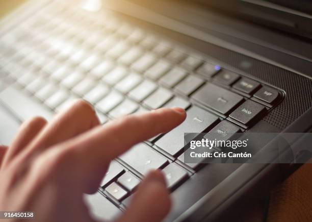 hand using laptop - enter key stock pictures, royalty-free photos & images