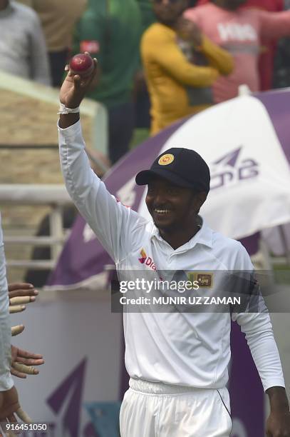 Sri Lanka cricketer Akila Dananjaya acknowledges the applause after capturing five Bangladeshi wickets at the end of the third day of the second...