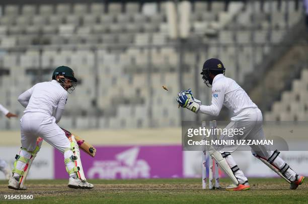 Sri Lanka wicketkeeper Niroshan Dickwella successfully breaks the stumps of the Bangladesh cricketer Mushfiqur Rahim during the third day of the...