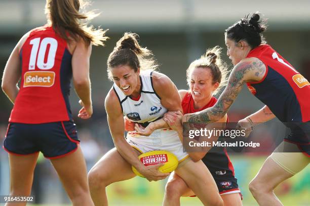 Daisy Pearce of the Demons tackles Angela Foley of the Crows during the round two AFLW match between the Melbourne Demons and the Adelaide Crows at...