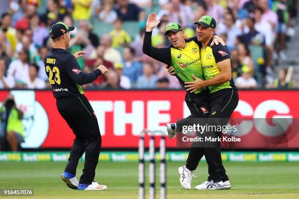 Arcy Short, David Warner and Marcus Stoinis of Australia celebrate Warner running out Dawid Malan of England during game two of the International...