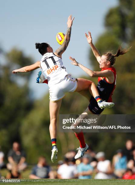 Rhiannon Metcalfe of the Crows and Erin Hoare of the Demons compete in a ruck contest during the 2018 AFLW Round 02 match between the Melbourne...