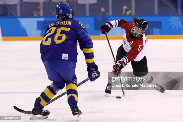Sena Suzuki of Japan skates against Hanna Olsson of Sweden during the Women's Ice Hockey Preliminary Round - Group B game on day one of the...