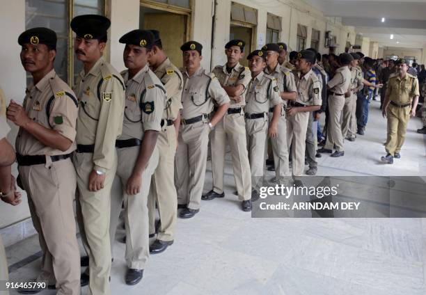 Indian paramilitary force personnel, recruited for election duty during the upcoming elections, stands in a queue to cast their vote in a ballot box...