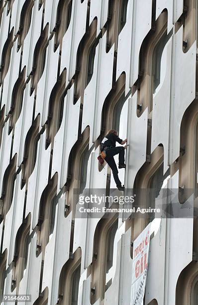 Spiderman, Alain Robert, climbs the Ariane Tower in the business center of Paris on October 8, 2009 in Paris, France. The Ariane Tower is 152m high...