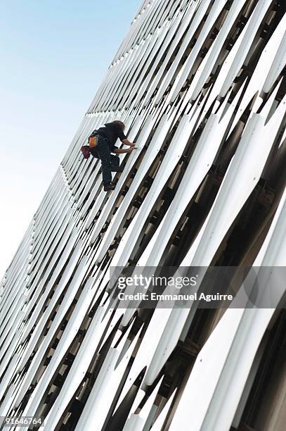 Spiderman, Alain Robert, climbs the Ariane Tower in the business center of Paris on October 8, 2009 in Paris, France. The Ariane Tower is 152m high...