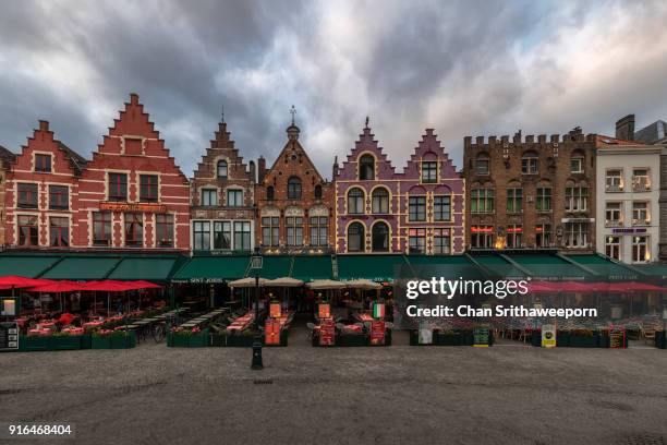 shops housed in typical medieval buildings, bruges, belgium - belgium canal stockfoto's en -beelden