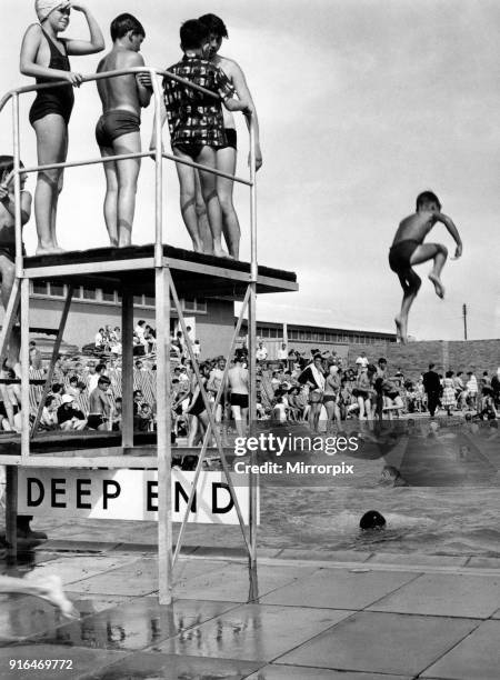 Holiday makers enjoy the Swimming and Paddling Pools at Trecco Bay, Porthcawl, Bridgend, South Wales, 22nd August 1964.