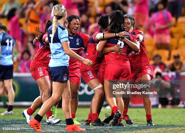 The Queensland Reds celebrate victory after defeating the New South Wales Blues in the Women's Grand Final match during the 2018 Global Tens at...