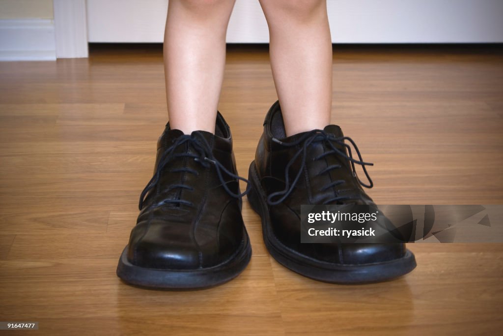 Closeup of Toddlers Legs Wearing Large Adult Shoes