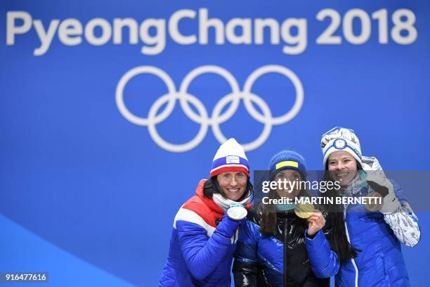 Sweden's Charlotte Kalla , Norway's Marit Bjoergen and Finland's Krista Parmakoski celebrate on the podium during the medal ceremony at the end of...