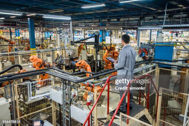 factory engineer inspecting the work process - factory ipad stock pictures, royalty-free photos & images