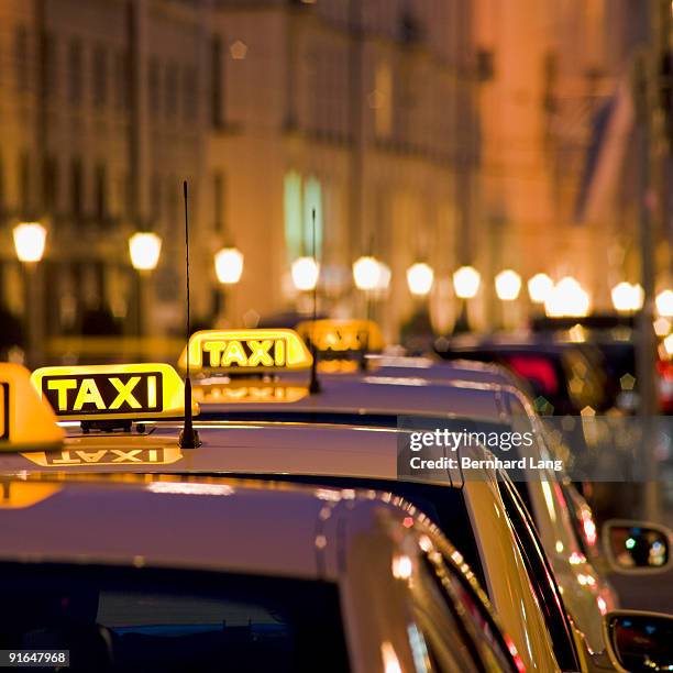 illuminated taxi signs - taxi sign stock pictures, royalty-free photos & images